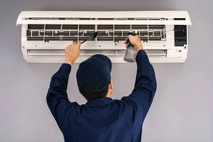 Indoor mini-split air conditioner being cleaned for better airflow