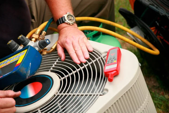 HVAC diagnostic tools measuring a residential cooling system